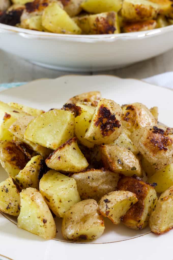 Very close up side view of one serving of potatoes in a china plate.