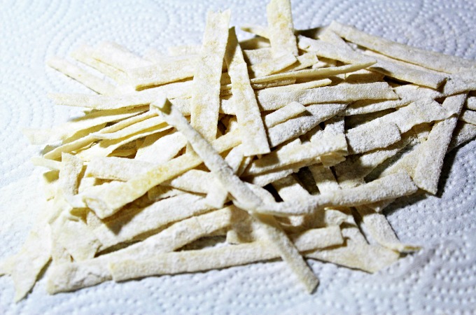a stack of homemade noodles that have been cut into smaller pieces.