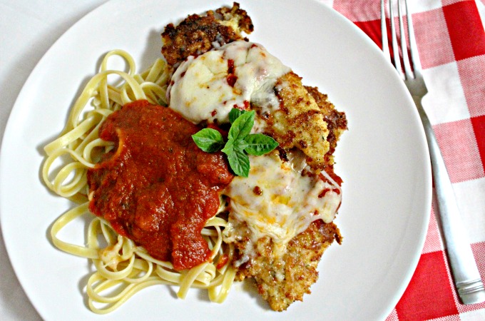 This is an easy Chicken Parmesan recipe that combines bread crumbs and cheese to coat the chicken and is served with jar sauce and long pasta.