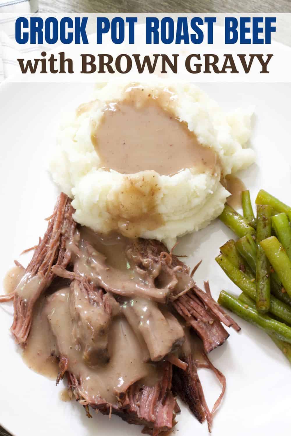 Close up view of a plate with roast beef and mashed potatoes and gravy. 