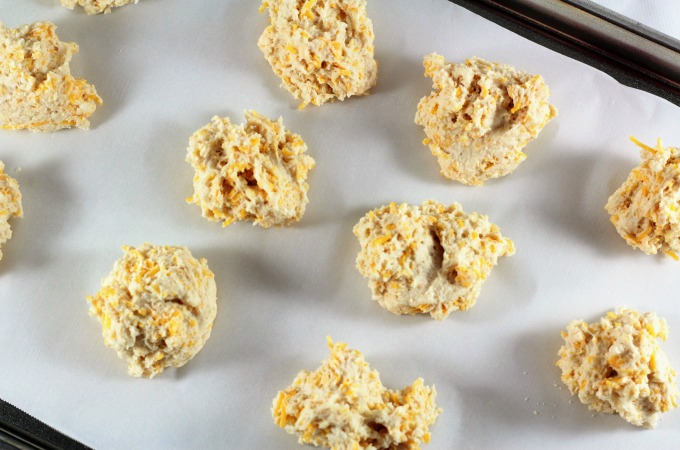 Easy Cheesy Drop Biscuits are light and fluffy with a hint of garlic, topped with butter. Heart Smart Bisquick makes them super simple and fast to make. 