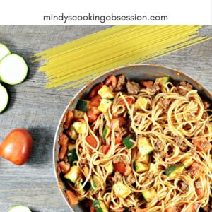 Spaghetti with Zucchini & Tomatoes combines pasta, ground beef, onions, tomato sauce, seasonings, zucchini, and tomatoes. It is fast and healthy.