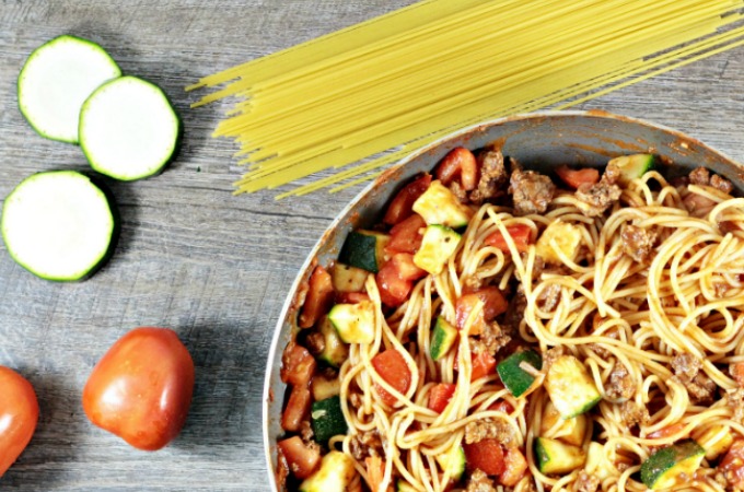 Spaghetti with Zucchini & Tomatoes combines pasta, ground beef, onions, tomato sauce, seasonings, zucchini, and tomatoes. It is fast and healthy.