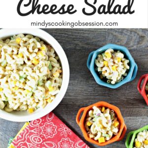 Macaroni & Cheese Salad combines elbow macaroni, cheese cubes, celery, red onion, Dijon mustard, mayo, sour cream, salt, pepper, and sugar.