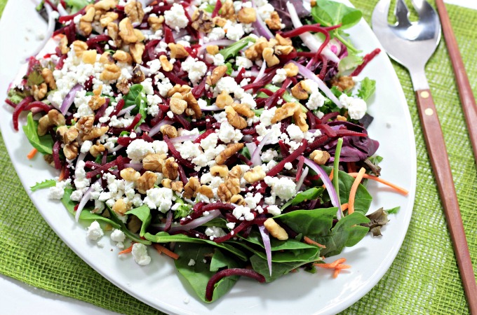 Baby Greens Salad with Beets & Goat Cheese also features red onion and walnuts, topped with orange vinaigrette. Great for winter or any time of the year.