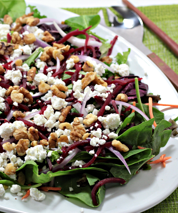 Baby Greens Salad with Beets & Goat Cheese also features red onion and walnuts, topped with orange vinaigrette. Great for winter or any time of the year. 