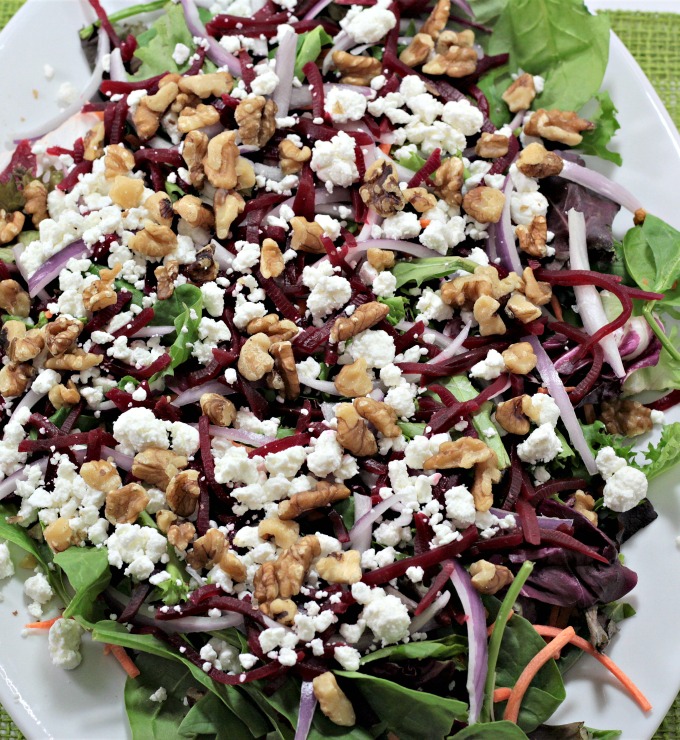 Baby Greens Salad with Beets & Goat Cheese also features red onion and walnuts, topped with orange vinaigrette. Great for winter or any time of the year. 