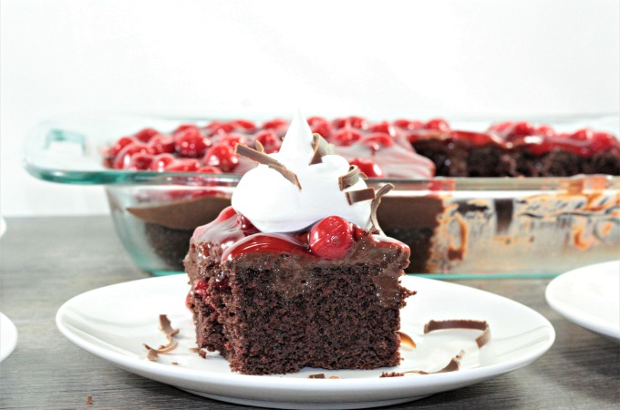 Black Forest Poke Cake features boxed cake mix, chocolate pudding, cherry pie filling, Cool Whip, and shaved chocolate. An easy and delicious dessert.