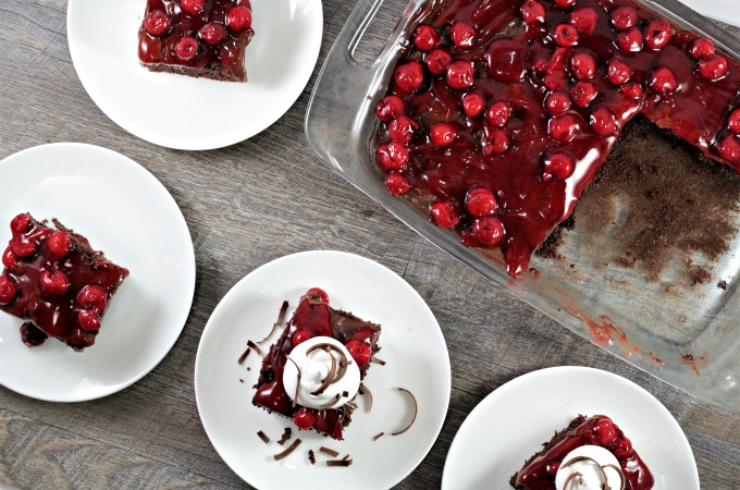 Black Forest Poke Cake features boxed cake mix, chocolate pudding, cherry pie filling, Cool Whip, and shaved chocolate. An easy and delicious dessert.