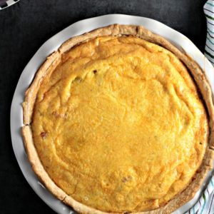 Ham and Potato Quiche features eggs, heavy cream, diced ham, potatoes, and onions, and of course cheddar cheese. Great for breakfast, brunch, or dinner!