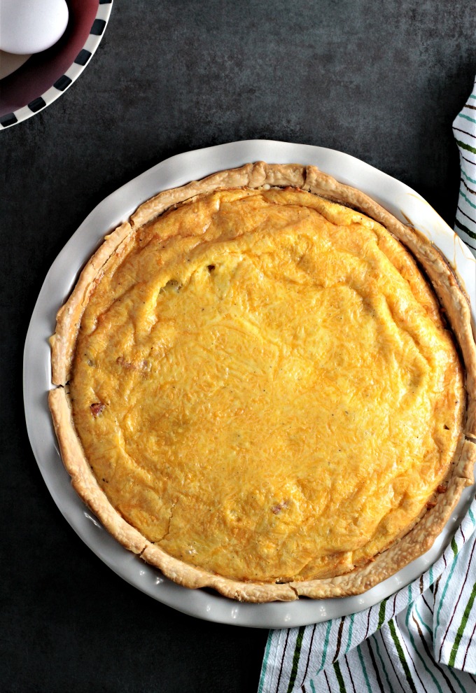 Ham and Potato Quiche features eggs, heavy cream, diced ham, potatoes, and onions, and of course cheddar cheese. Great for breakfast, brunch, or dinner!