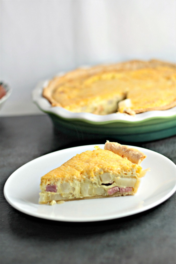 Ham and Potato Quiche features eggs, heavy cream, diced ham, potatoes, and onions, and of course cheddar cheese. Great for breakfast, brunch, or dinner!