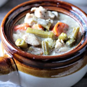 Healthier Slow Cooker Chicken Stew combines chicken, potatoes, celery, green beans, carrots, buttermilk, milk, sour cream, and spices to make healthy stew.