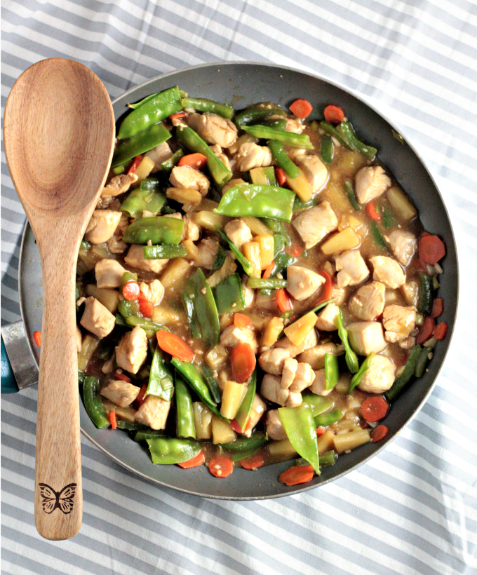 Pineapple Chicken Stir Fry combines chicken, carrots, bell peppers, snow peas, pineapples and juice, soy sauce, and broth. Healthy, quick and delicious!