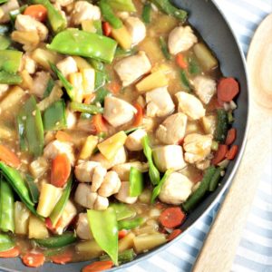 Pineapple Chicken Stir Fry combines chicken, carrots, bell peppers, snow peas, pineapples and juice, soy sauce, and broth. Healthy, quick and delicious!