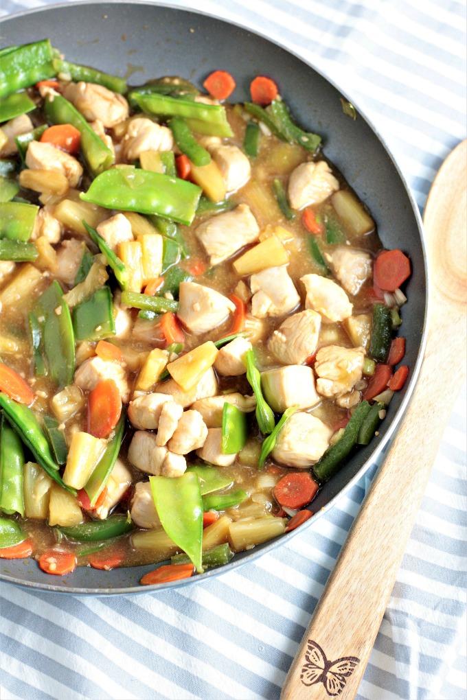 Pineapple Chicken Stir Fry combines chicken, carrots, bell peppers, snow peas, pineapples and juice, soy sauce, and broth. Healthy, quick and delicious!