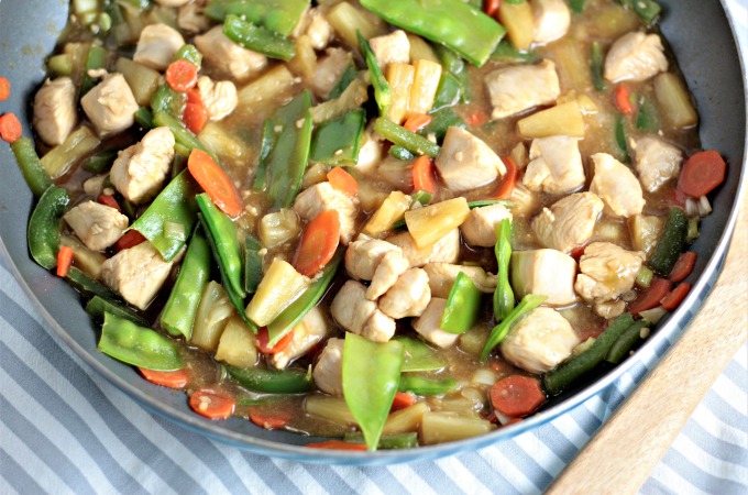 Pineapple Chicken Stir Fry combines chicken, carrots, bell peppers, snow peas, pineapples and juice, soy sauce, and broth. Healthy, quick and delicious!