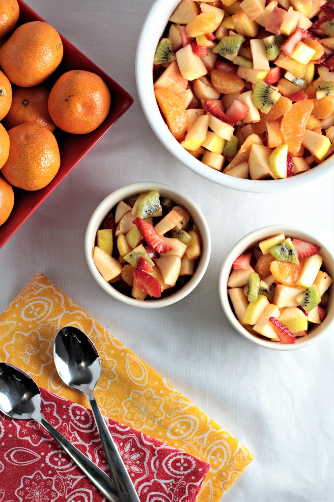 Refreshing Winter Fruit Salad features red and green apple, kiwi, strawberry, pineapple, and mandarin oranges topped with a honey lemon dressing. Healthy!