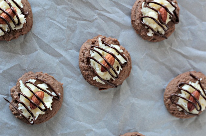 Almond Joy Cookies feature a light and fluffy chocolate cookie baked to perfection, topped with sweet gooey coconut candy then drizzled with chocolate. 