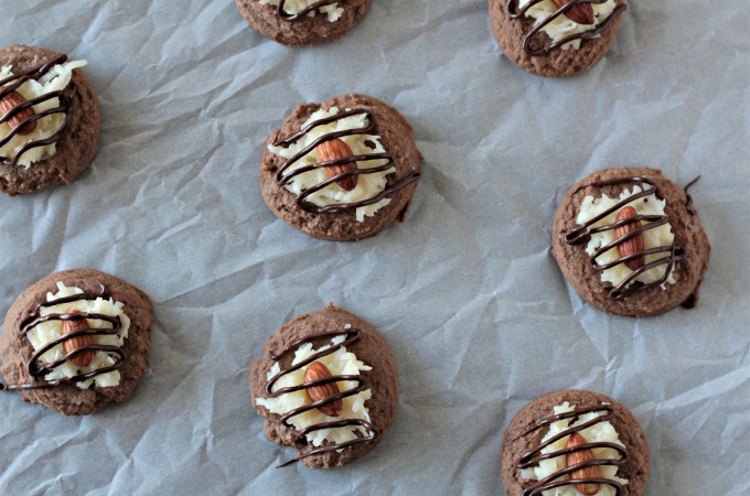 Almond Joy Cookies feature a light and fluffy chocolate cookie baked to perfection, topped with sweet gooey coconut candy then drizzled with chocolate. 