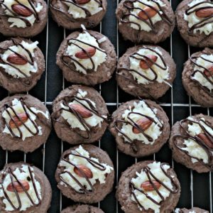 Almond Joy Cookies feature a light and fluffy chocolate cookie baked to perfection, topped with sweet gooey coconut candy then drizzled with chocolate.