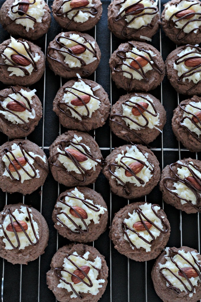 Almond Joy Cookies feature a light and fluffy chocolate cookie baked to perfection, topped with sweet gooey coconut candy then drizzled with chocolate.