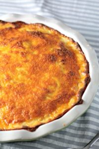 Cheesy Scalloped Potatoes feature thinly slice layered potatoes topped with a cheesy béchamel sauce made of milk, butter, flour, onion, and cheese.