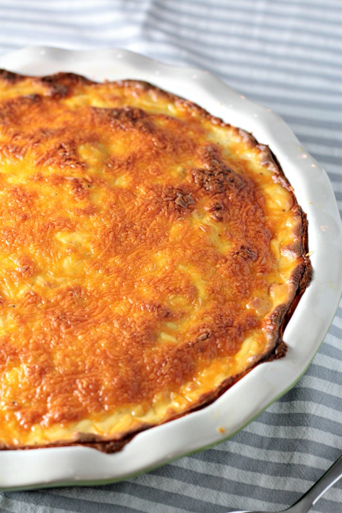 Cheesy Scalloped Potatoes feature thinly slice layered potatoes topped with a cheesy béchamel sauce made of milk, butter, flour, onion, and cheese. 