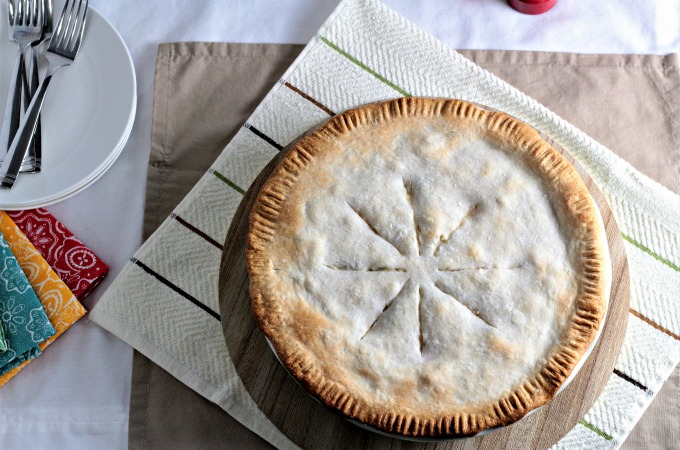 Chicken Pot Pie features store bought crust, cooked chicken, peas, corn, carrots, green beans, and potatoes in a creamy sauce. 