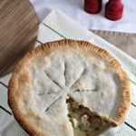 Chicken Pot Pie features store bought crust, cooked chicken, peas, corn, carrots, green beans, and potatoes in a creamy sauce.