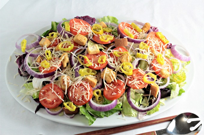 Italian Style Salad: Romaine mix, butter, and baby red lettuces, radicchio, Roma tomatoes, red onion, pepperoncini, Parmesan cheese, and croutons.