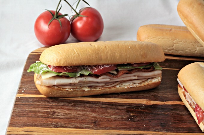 Turkey BLT features bacon, lettuce, tomato, Swiss cheese, cream cheese, Parmesan cheese, and Italian dressing on a hoagie bun. Simply the best Turkey BLT!