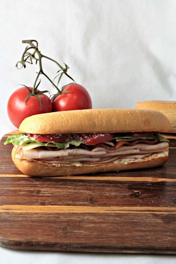 Turkey BLT features bacon, lettuce, tomato, Swiss cheese, cream cheese, Parmesan cheese, and Italian dressing on a hoagie bun. Simply the best Turkey BLT!