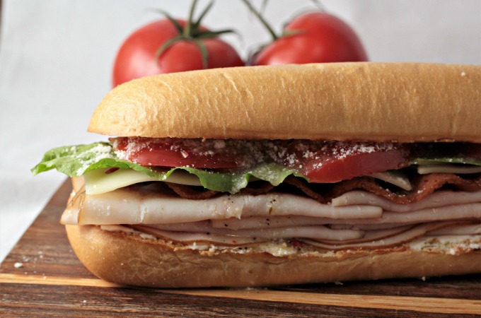 Turkey BLT features bacon, lettuce, tomato, Swiss cheese, cream cheese, Parmesan cheese, and Italian dressing on a hoagie bun. Simply the best Turkey BLT!