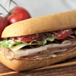 Turkey BLT features bacon, lettuce, tomato, Swiss cheese, cream cheese, Parmesan cheese, and Italian dressing on a hoagie bun. Simply the best Turkey BLT!