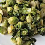 Super Easy Pan Fried Fresh Brussels Sprouts combine Brussels sprouts, olive oil, garlic, salt, pepper, and water to make a healthy and easy side dish.