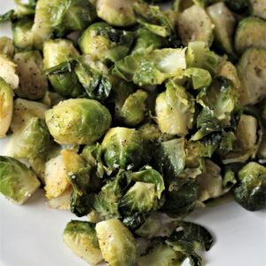 Super Easy Pan Fried Fresh Brussels Sprouts combine Brussels sprouts, olive oil, garlic, salt, pepper, and water to make a healthy and easy side dish.