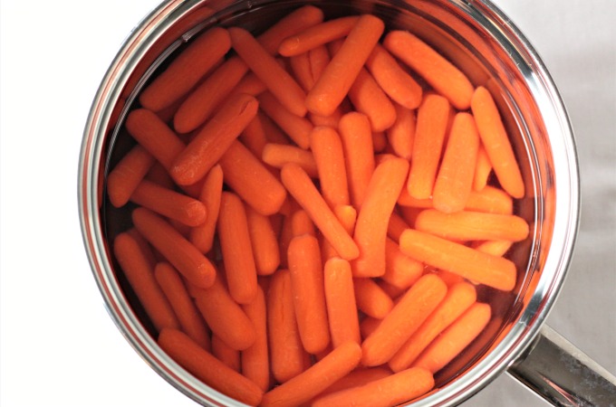 Honey Glazed Baby Carrots combine carrots, butter, and honey to make a delicious and healthy 3 ingredients vegetarian side dish the kids will love. 