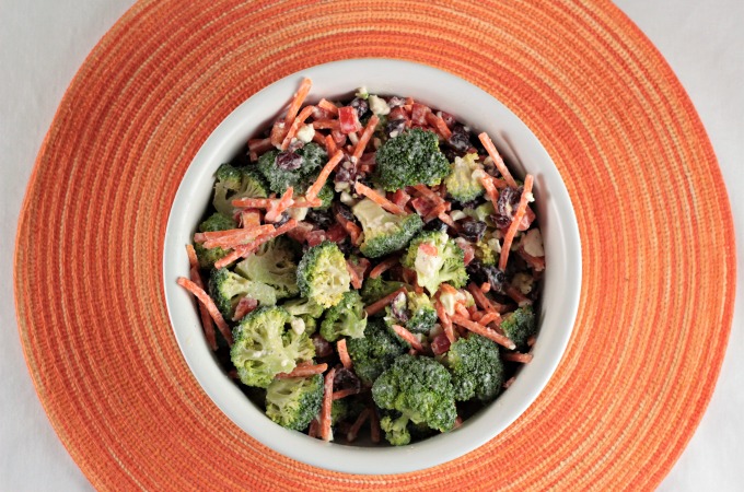 Broccoli Salad with Creamy Feta Dressing combines fresh broccoli, bell pepper, carrots, craisins, yogurt, lemon juice and pepper to make an easy side dish. 