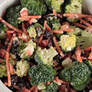 Broccoli Salad with Creamy Feta Dressing combines fresh broccoli, bell pepper, carrots, craisins, yogurt, lemon juice and pepper to make an easy side dish.