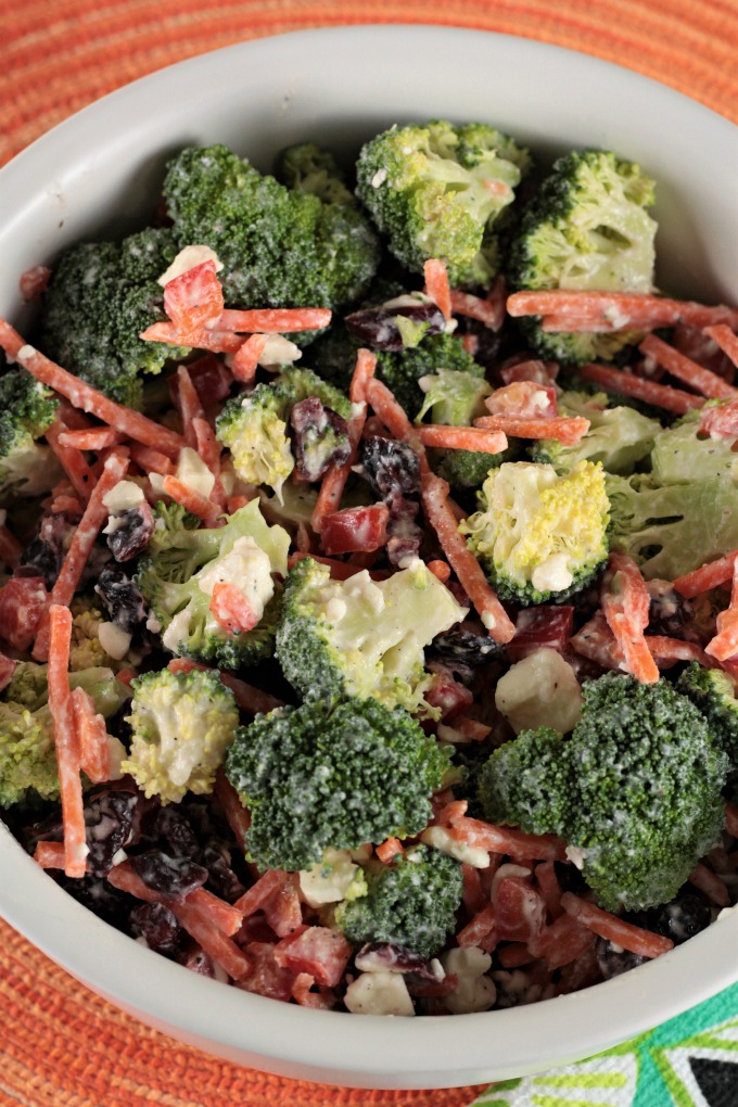 Broccoli Salad with Creamy Feta Dressing combines fresh broccoli, bell pepper, carrots, craisins, yogurt, lemon juice and pepper to make an easy side dish. 