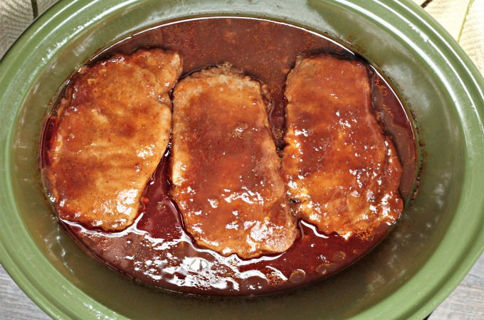 Crockpot BBQ Cola Pork Chops only require a slow cooker and 4 ingredients; pork chops, barbecue sauce, Pepsi or Coke, and ketchup. Easy and delicious!