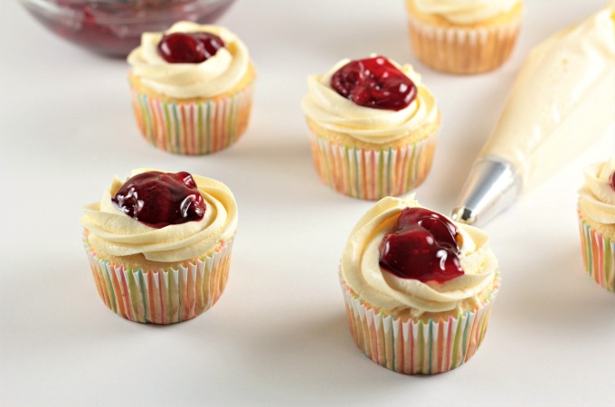 Strawberry Cheesecake Cupcakes transform a boxed white cake mix into a delicious treat with premade cheesecake filling and strawberry pie filling. So easy!