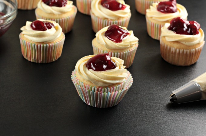 Strawberry Cheesecake Cupcakes transform a boxed white cake mix into a delicious treat with premade cheesecake filling and strawberry pie filling. So easy!