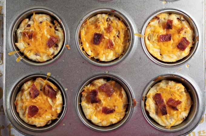 Baked Cheesy Mashed Potato Cups combine mashed potatoes, cheese, bacon, an egg, salt and pepper to make a versatile kid-friendly side dish or appetizer. 