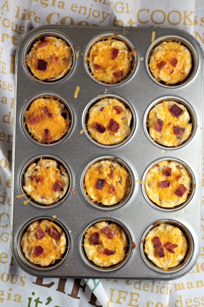 Baked Cheesy Mashed Potato Cups combine mashed potatoes, cheese, bacon, an egg, salt and pepper to make a versatile kid-friendly side dish or appetizer. 