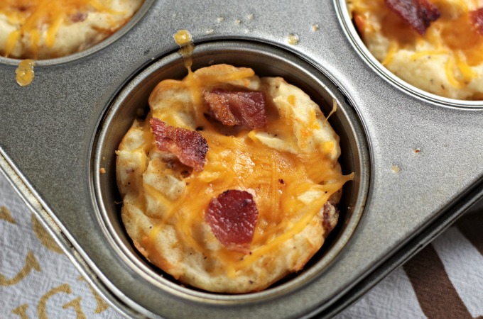 Baked Cheesy Mashed Potato Cups combine mashed potatoes, cheese, bacon, an egg, salt and pepper to make a versatile kid-friendly side dish or appetizer. 