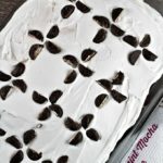 Peppermint Mocha Poke Cake features boxed chocolate cake, International Delight creamer, pudding, whipped topping and peppermint patty candies.