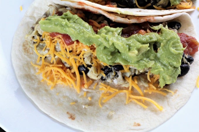 Avocado Breakfast Soft Tacos-scrambled eggs, black beans, cheese, salsa, and avocado atop a warm flour tortilla, perfect breakfast, brunch, lunch or dinner!
