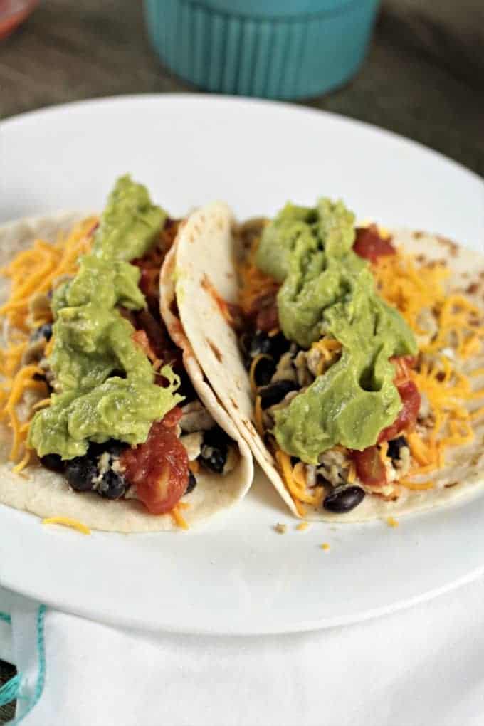 Avocado Breakfast Soft Tacos-scrambled eggs, black beans, cheese, salsa, and avocado atop a warm flour tortilla, perfect breakfast, brunch, lunch or dinner!